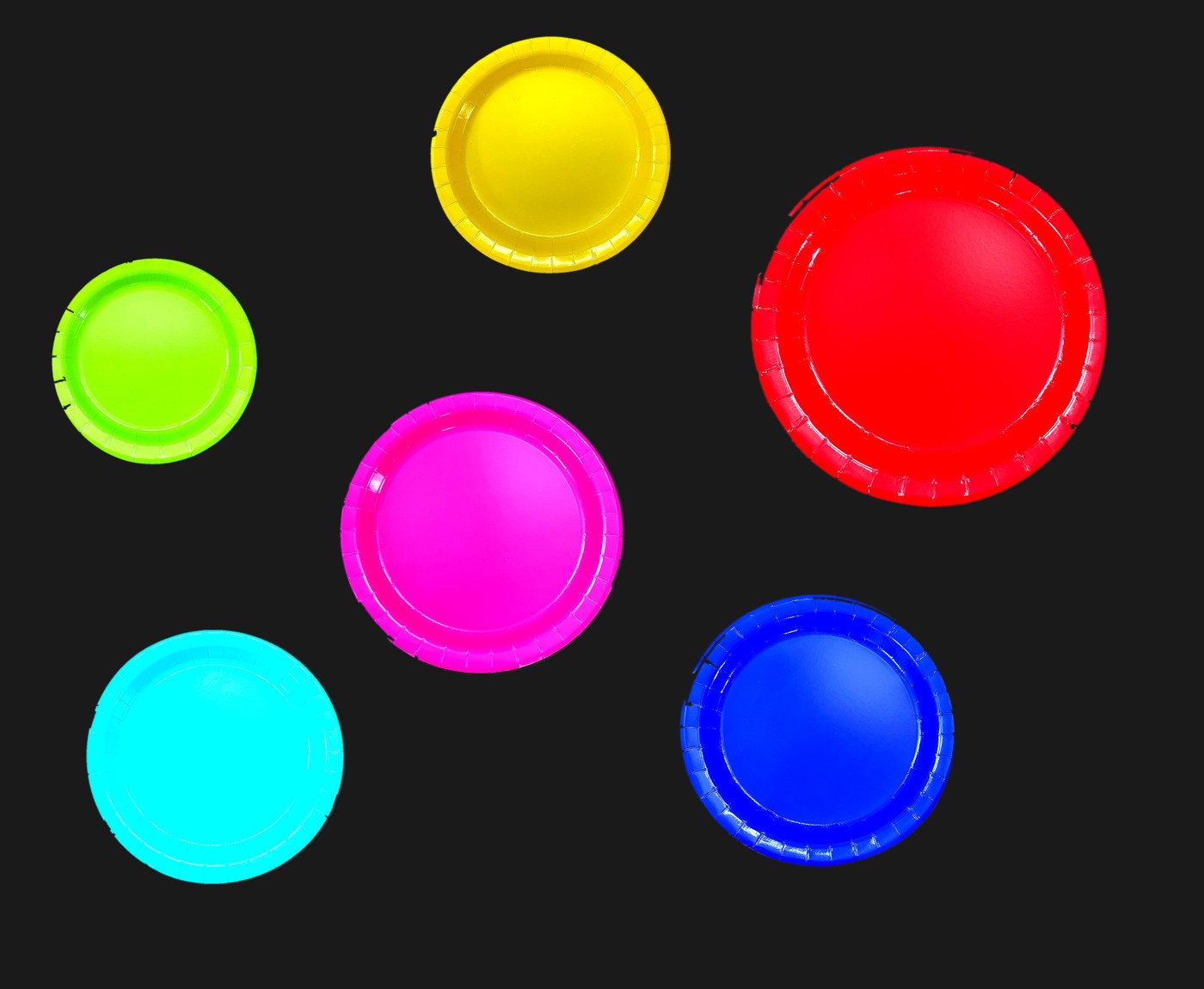 Paper plates in vivid colors on a dark background