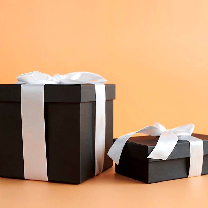 Black gift boxes with white ribbon